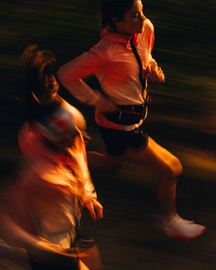 Two women running in golden evening light