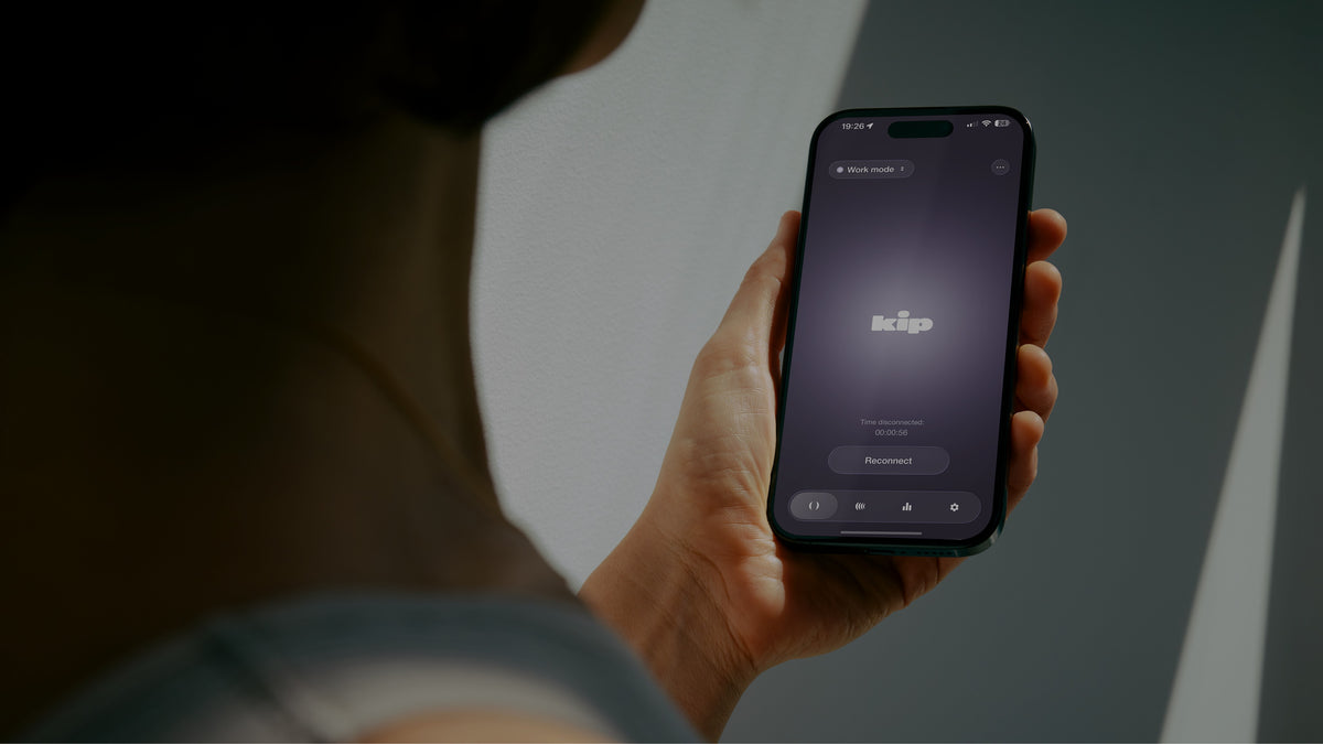A phone in hand running the kip app
